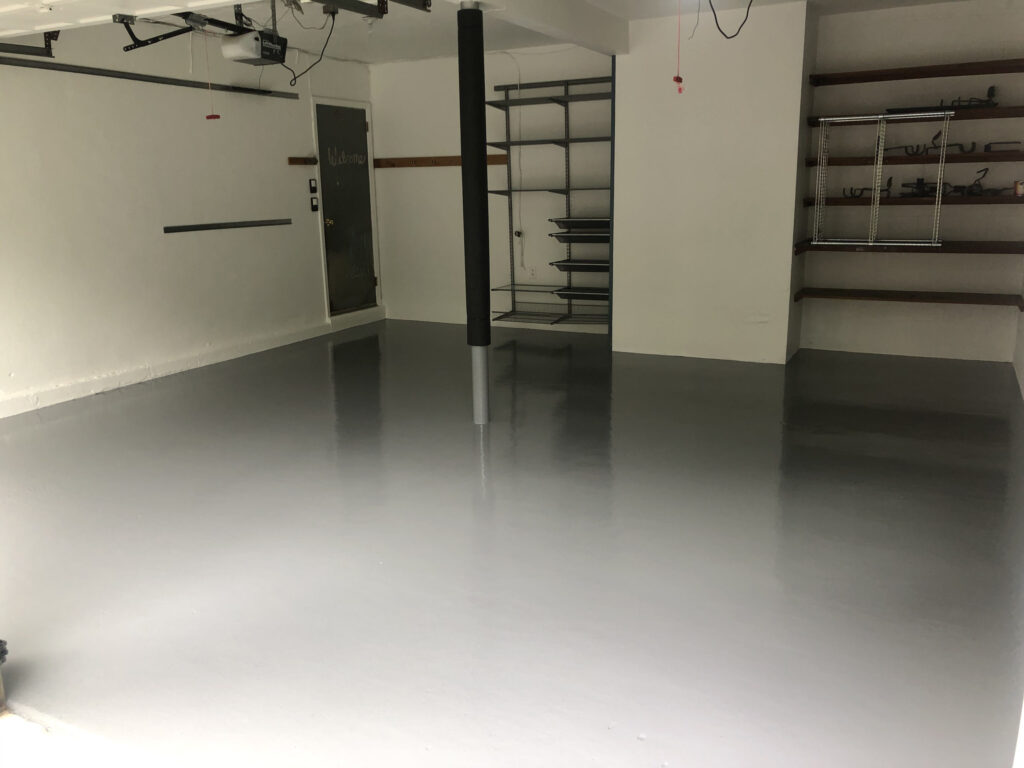 Epoxy Floor Paint in a garage with tools and workbench | Image Credit: foxpaintingcompany.com
